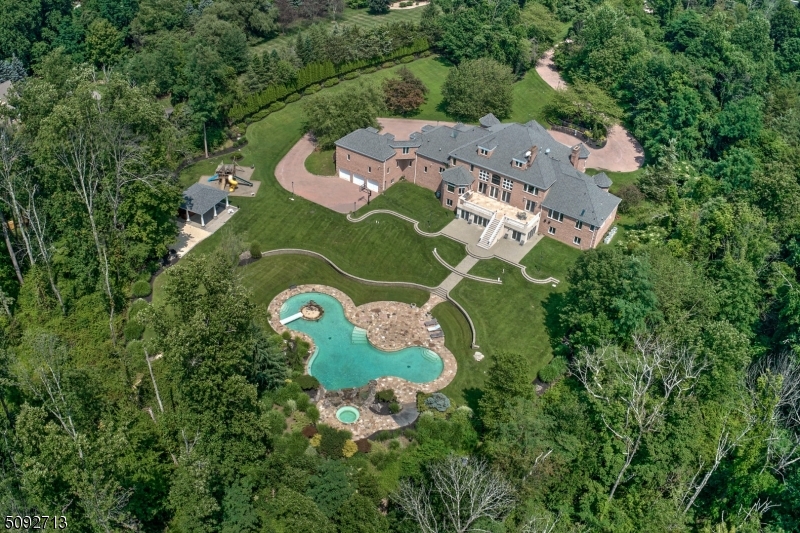 Classic brick manor with resort pool area on almost twelve acres of lush grounds.