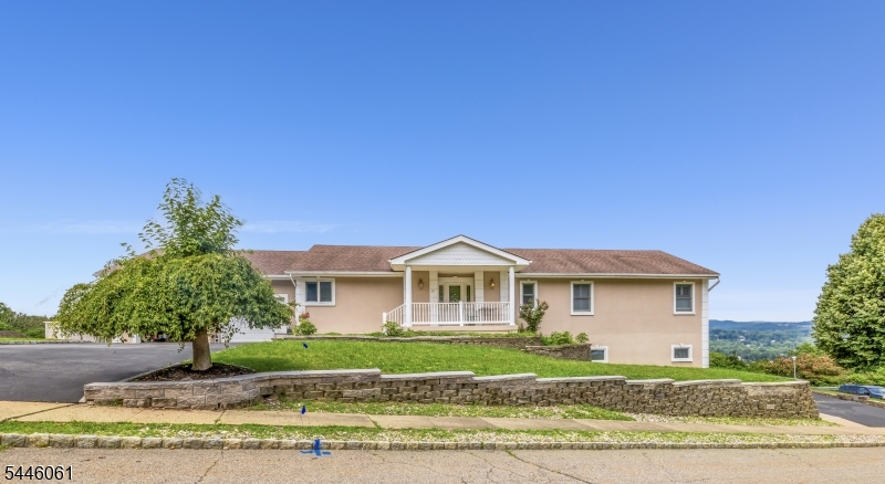 IMPRESSIVE FEATURES! Two Driveways, Separate entrances, two levels of outdoor accesses, Two Full Kitchens, Separate Laundry hook ups for each floor.