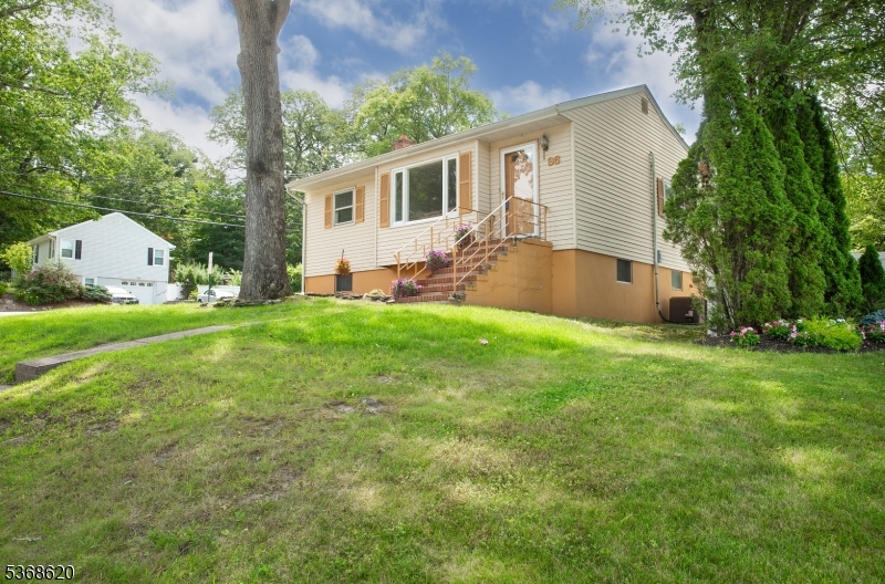 Welcome to 96 Yawpo Avenue! Set on a lush, elevated lot in a peaceful Oakland neighborhood, this charming home greets you with manicured landscaping, a classic brick staircase, and a large bay window that fills the living space with natural light.