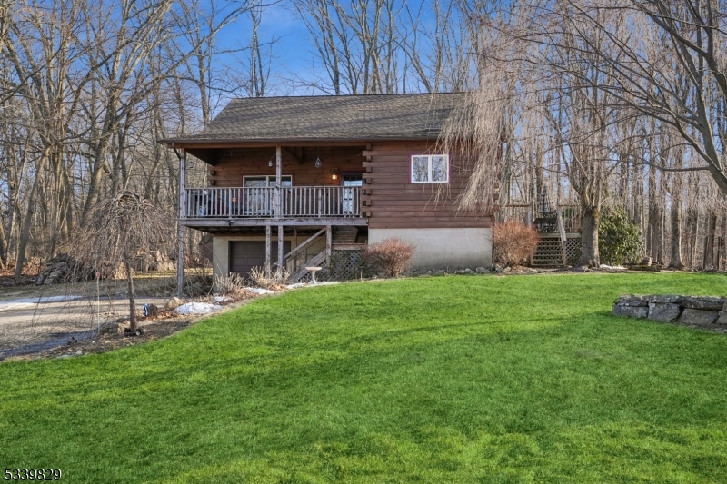 This charming log home is privately set back off the road, nestled on over half an acre of beautiful property, offering peace and tranquility