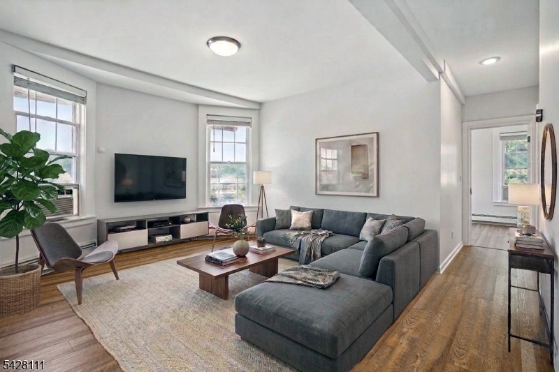 Virtually Staged Living Room to Windows with Sunset Views of the South Mountain Reservation