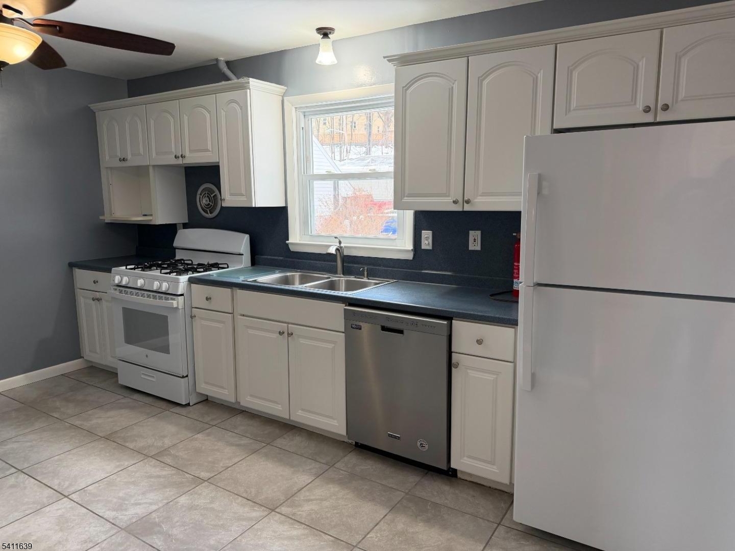 Large eat in kitchen with modern appliances. Bright window over the stainless steel kitchen sink.