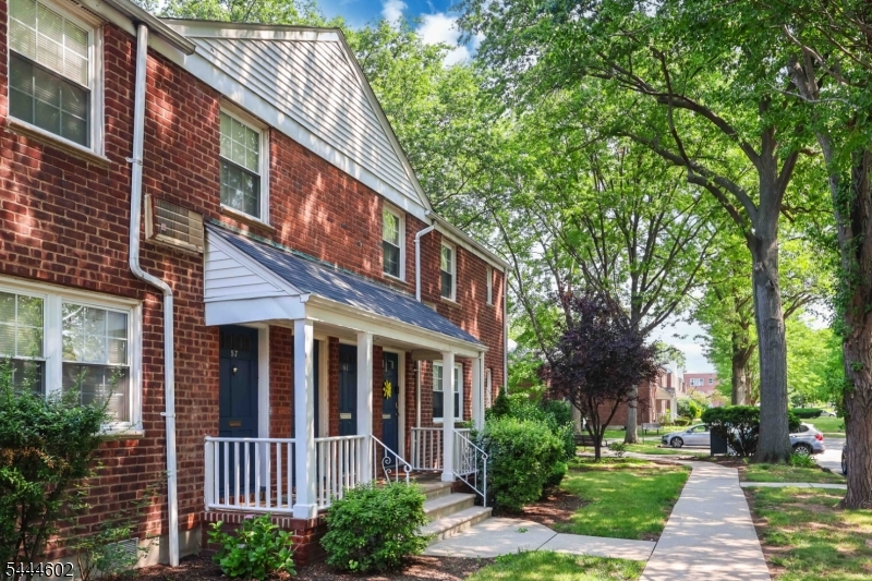 Front View attractive brick building with mature landscaping.