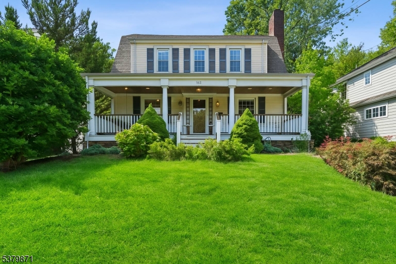 Front Charming colonial with inviting curb appeal, spacious front yard, and a welcoming covered porch.
