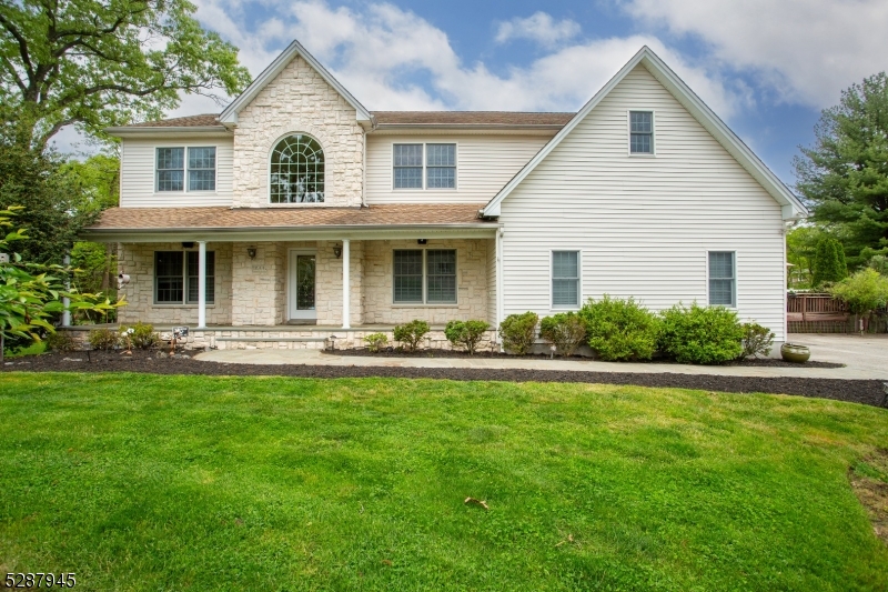 Charming colonial in Parsippany's sought-after neighborhood boasts a 5-bed, 3.5-bath layout. Original homeowner adds character. Features an inviting open front portico porch entry, marrying classic charm with modern luxury.