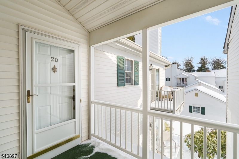 Second floor entry with storm door.