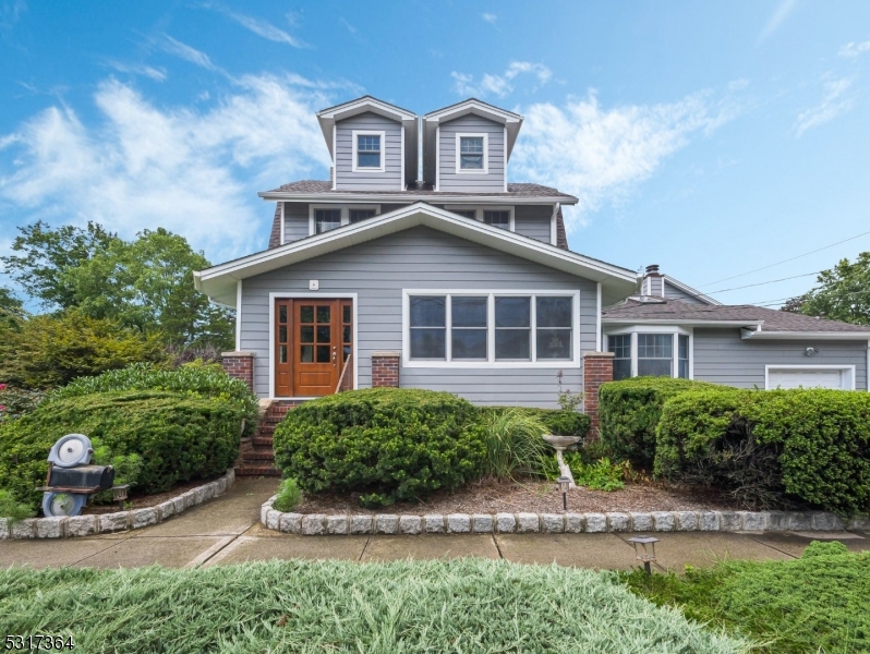 This charming 4-bedroom, 5-bathroom Colonial features a sunroom, multiple living spaces, an expansive outdoor area with a multi-level patio, fire pit, pool, and garden, all set on a private lot perfect for entertaining.