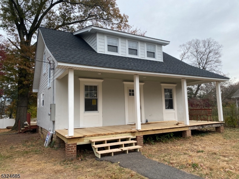 Who doesn't love a front porch? This 28-foot brand new cedar wood  topped covered porch has all new support posts and will be finished off with Azek trim to cover floor joists.