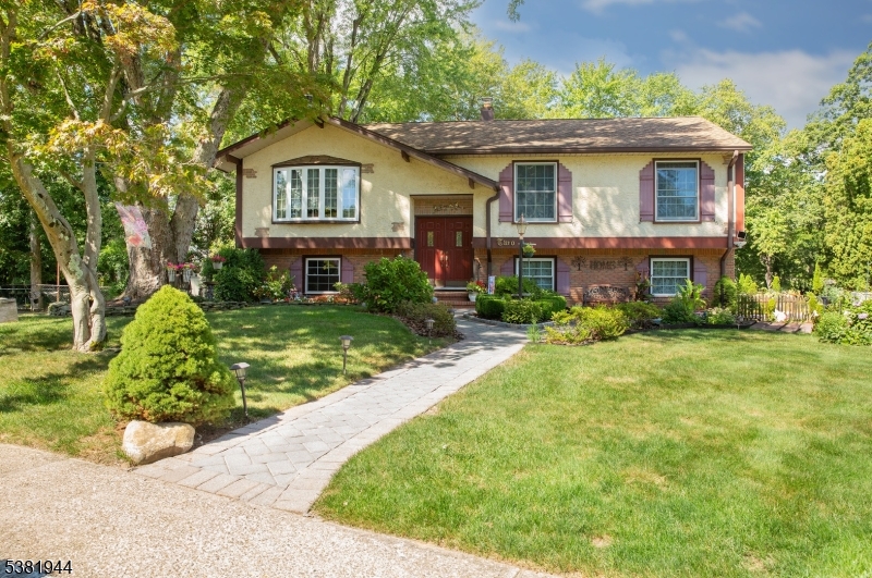 Beautifully maintained front exterior with manicured lawn, blooming gardens, and mature shade trees. This home exudes curb appeal and pride of ownership in a desirable cul-de-sac location, offering comfort, charm, and a welcoming first impression.