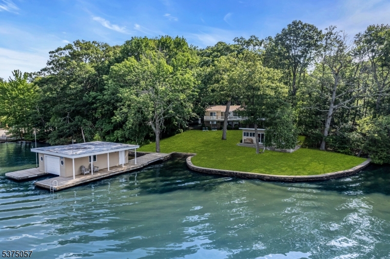 2 2-story custom Lake House offers Extra building lot, 3 car garage, boat house and cabana