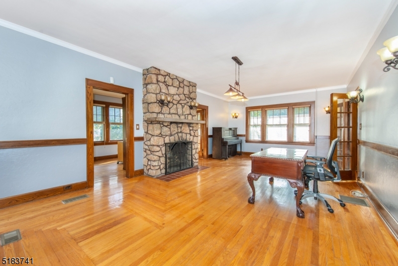 Custom designed wood flooring. Crown molding. Floor to ceiling stone wood-burning fireplace. Two entries to den/leisure room.