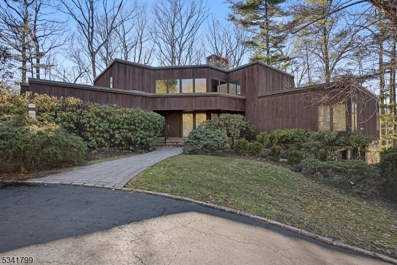 3BR, 3.1 BA mid-century modern gem set on 1.5 acres of private wooded landscape in desirable neighborhood in Watchung.