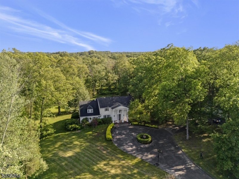 Paved Circular driveway, nestled behind a gated fence