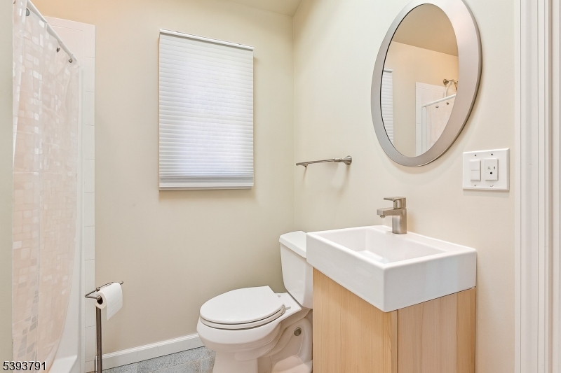 Pool House Bathroom The full bathroom is equipped with a tub shower and storage vanity.