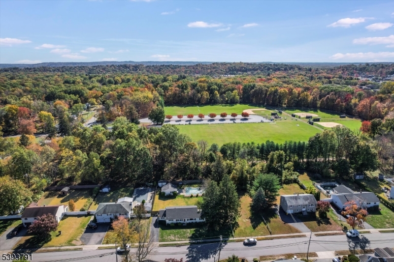 Located by town park Charming ranch home set on a level property featuring an inviting inground pool and a spacious pool house, perfect for entertaining or relaxing