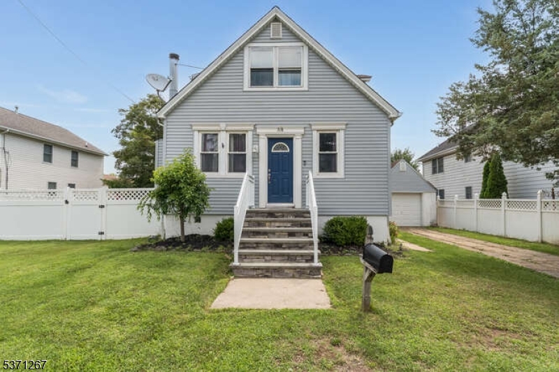 FRONT ELEVATION Stone steps and an attractive façade welcome you to this charming expanded Cape Cod home.
