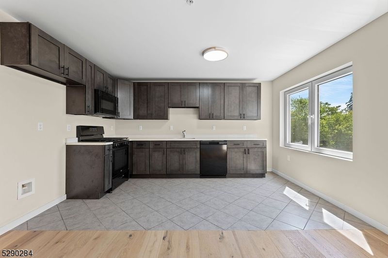 SHAKER CABINETS WITH QUARTZ COUNTERTOPS. TENANT TO BRING OWN REFRIGERATOR.