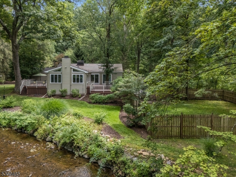 Scenic backyard with lush landscaping and peaceful creek frontage. Enjoy the natural beauty, fenced yard, and privacy this unique property offers from every angle.