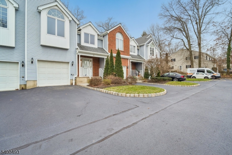 Front view from private road park in driveway, one additional reserved space & guest parking