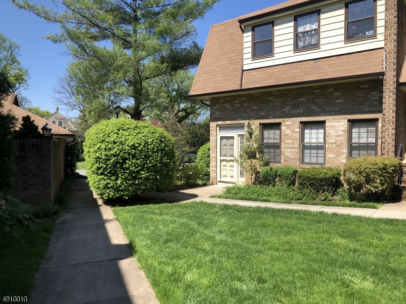 Brick construction with vinyl trim...walking path and mature foliage