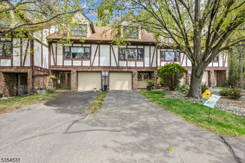 Welcome home to this beautifully maintained 2 bedroom 1.5 bathroom Tudor style townhouse nested on a serene wooded lot.