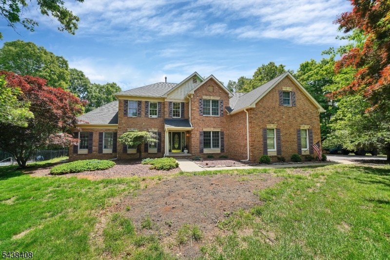 Brick front colonial on a flag lot with beautiful views & privacy!