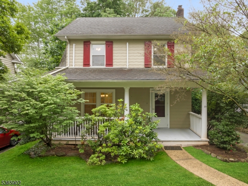 Front Beautifully maintained two-story exterior featuring a welcoming covered porch, mature landscaping, and classic shutters.