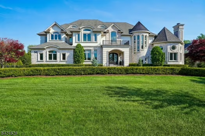 Front view Magnificent Estate Showcasing Exceptional Curb Appeal, Circular Paver Driveway & Professionally Landscaped Grounds