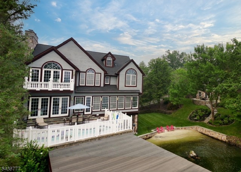 Exterior Three building lakefront estate with private beach comprised of main house, carriage house and boat house.