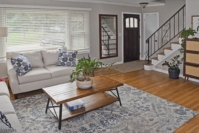 Spacious and inviting room with hardwood flooring and large picture window.