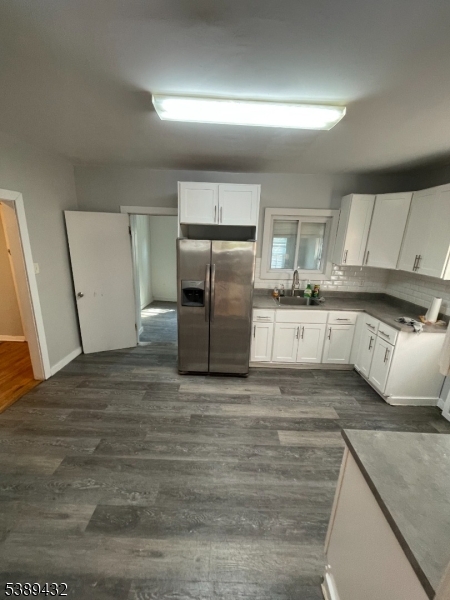 Kitchen Kitchen featuring white cabinets, stainless steel appliances, and ample space for storage and meal prep.