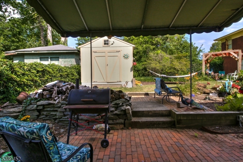 Awning provides shade Backyard with custom awning over patio is great shady space.