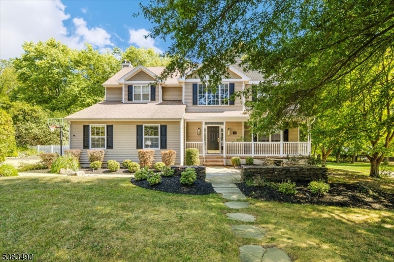 Welcome home! Relax on the front porch surrounded by professional landscaping.