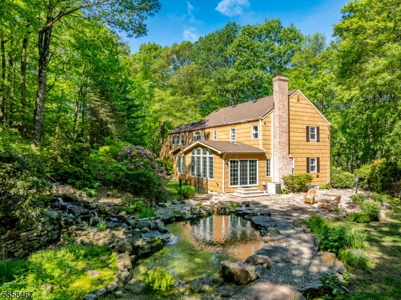 Tucked away in a tranquil forest, this beautifully maintained Colonial offers an extraordinary lifestyle with its stunning natural pond, cascading waterfall, and expansive stone patio.