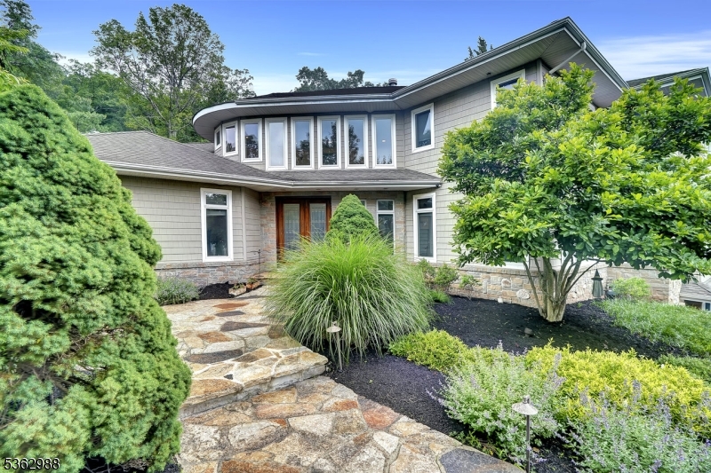 Custom paver walkway, surrounded by lush greenery!