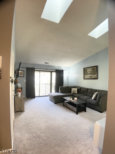 Living Room with Skylights & Balcony