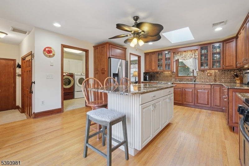 Laundry Room/Powder Room The laundry room, conveniently located off the kitchen, enhances the functionality of the home providing easy access for all one-level living.