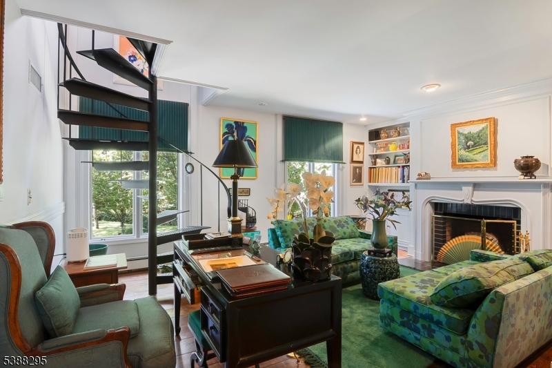 Library Room/FamilyRoom Previous owner used as their private library /office room with spiral stairway to master suite. It comes with gas FP and french door for privacy