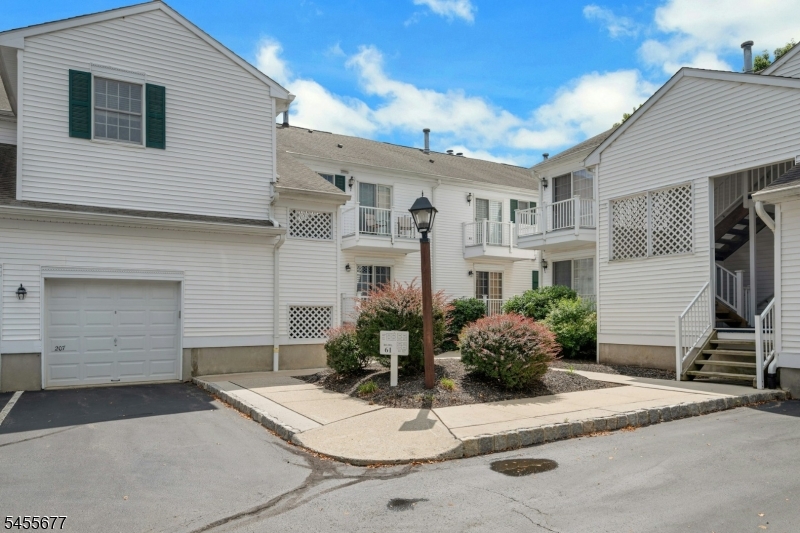 Well-maintained community exterior with landscaped grounds and garage access.