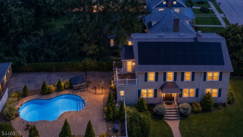 Full aerial front view of the entire house, including the pool and garage.