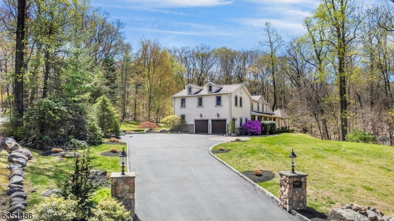 beyond the dual stone markers and recently resealed driveway.