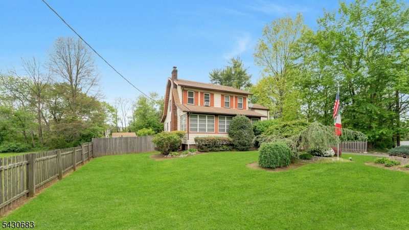 Front View Beautifully professionally landscaped grounds with privacy fence