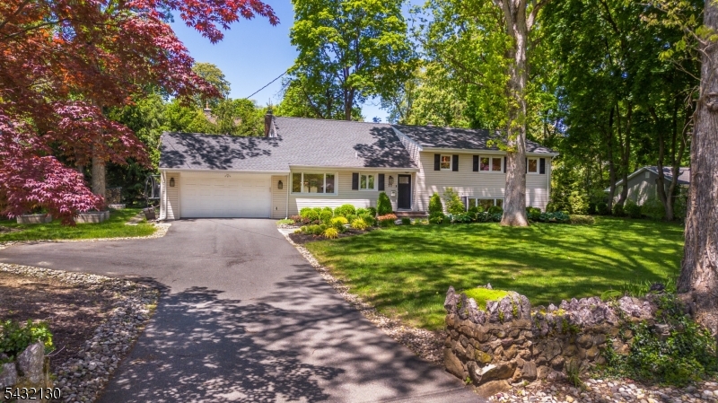 Set in an ideal location close to all schools in the center of town, this beautiful custom split level home awaits!