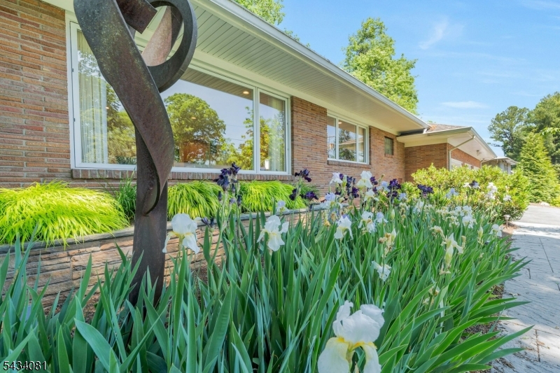 front of home with flowers